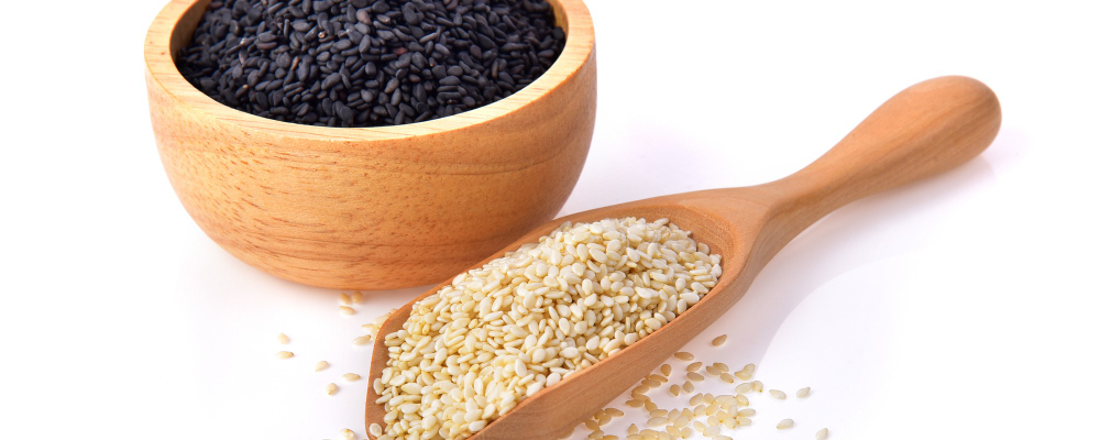 White sesame and black sesame seeds isolated on white background