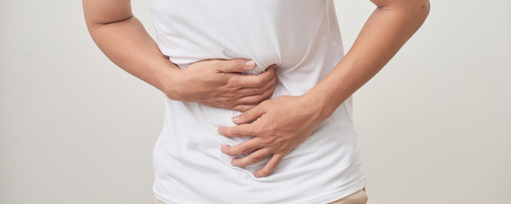 People healthcare and health problem concept unhappy man suffering from stomach ache over whit