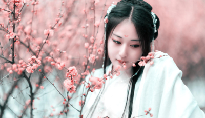 Young woman against cherry tree